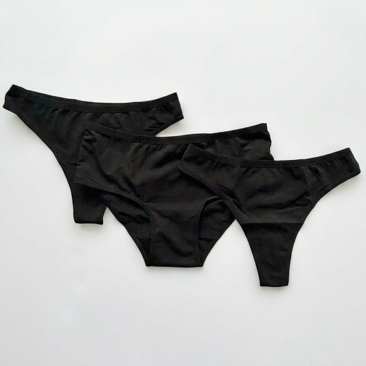 Three black women's underwear pieces on a white background