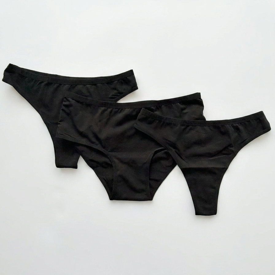 Three black women's underwear pieces on a white background
